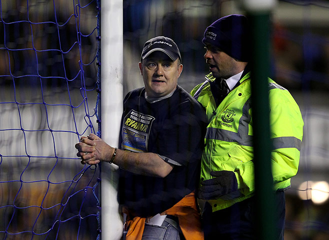 protests: A man handcuffs himself to the goal posts