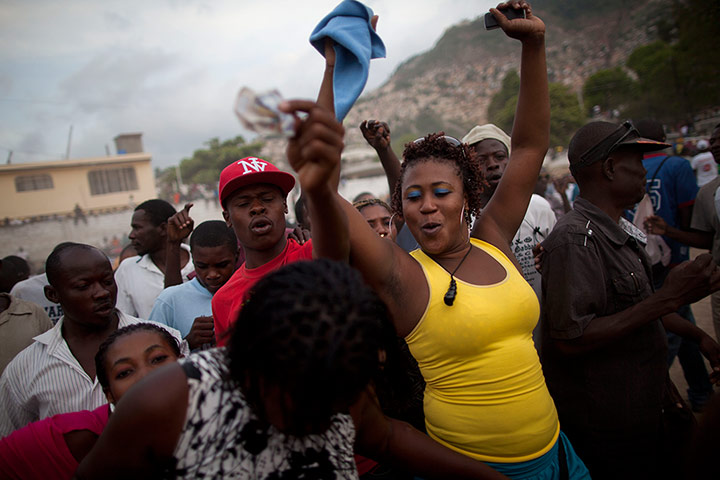Haiti - A longer view: People sing and dance before a traditional wrestling match
