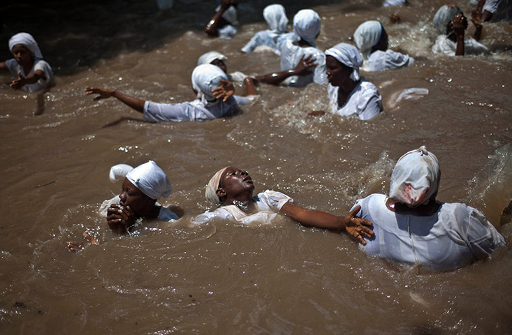 Haiti - A longer view: Believers swim in a sacred pool in Souvenance, Haiti