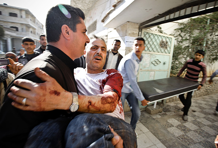 Aleppo, Syria: A man is carried in for medical treatment, Khan Sheyhoun