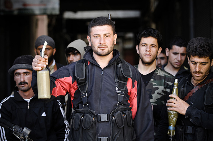 Aleppo, Syria: Rebels of the Free Syrian Army show off their Molotov cocktails