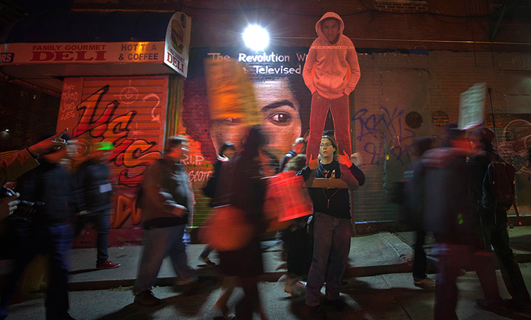 24 hours: New York, US: A man holds a cardboard cut-out of Trayvon Martin