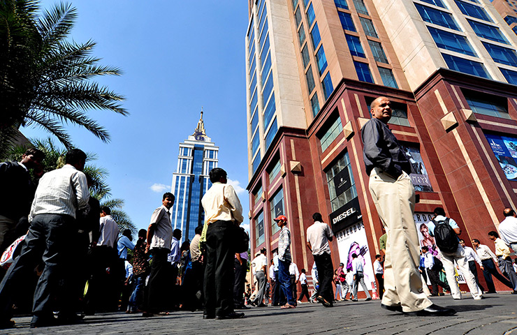 Indonesia earthquake: People stand outside their office building after tremors in Bangalore