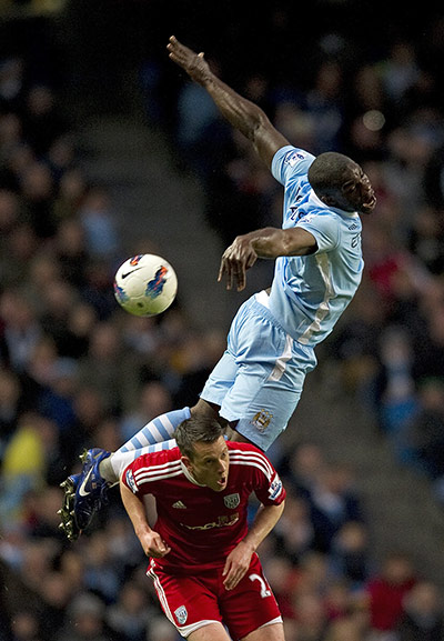 Wednesday footie: Micah Richards jumps for the ball above West Brom's Nicky Shorey