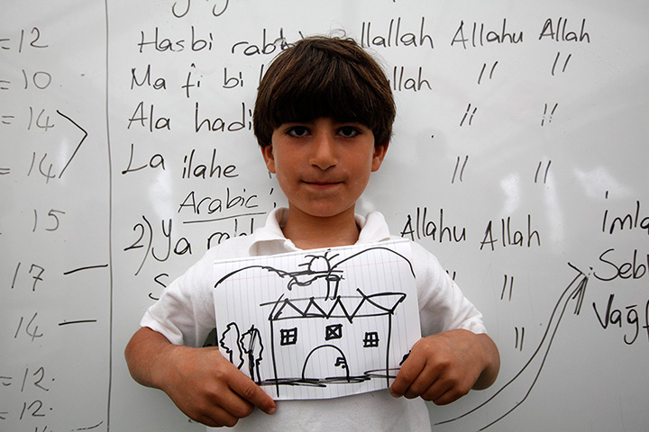 Boynuyogun refugee camp: Children show drawings of their dream home at Boynuyogun refugee camp