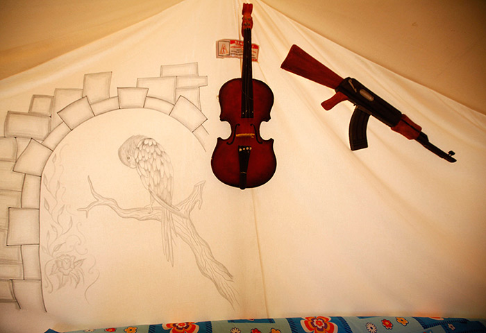Boynuyogun refugee camp: Drawing, toy gun and violin are seen on tent canvas at Boynuyogun camp