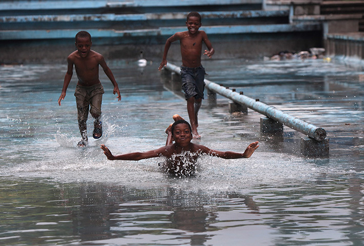 24 hours: Port au Prince, Haiti: Boys play at the Champ de Mars refugees' camp 
