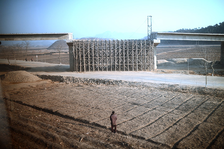 From the agencies: A man looks at a bridge under construction along the railway, Pyongyang