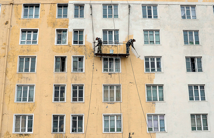 From the agencies: North Korean workers paint a building in Pyongyang