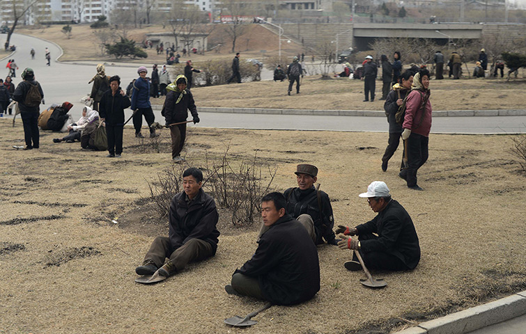 From the agencies: North Korean workers take a break in a street  of Pyongyang