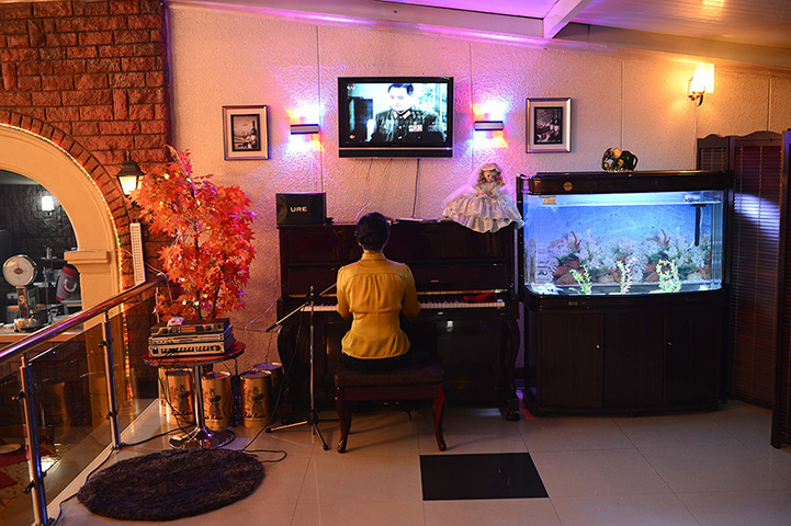 From the agencies: A woman plays the piano in a restaurant in Pyongyang
