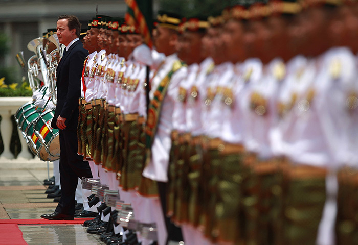 David Cameron in Asia: David Cameron walks past guards at Prime Minister Najib Razak's office