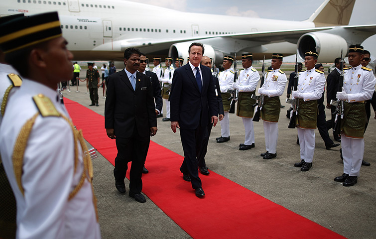 David Cameron in Asia: David Cameron walks past a guard of honour on arrival in Kuala Lumpur