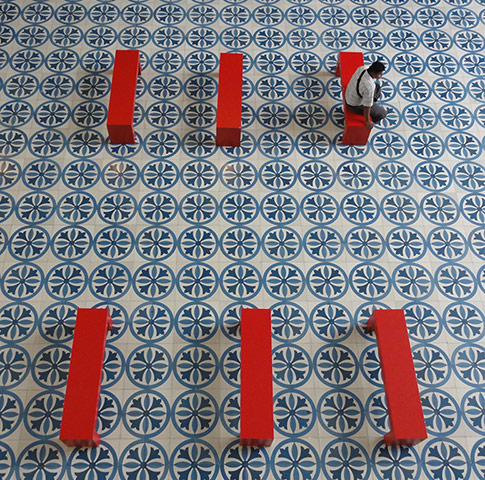 Your Pictures: Your Pictures: man sitting on a red bench on a geometric tilled floor