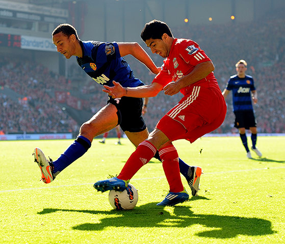liverpool signings: Luis Suarez of Liverpool competes with Rio Ferdinand of Manchester United