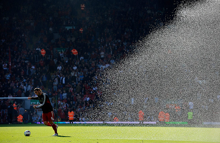 liverpool signings: Andy Carroll warms up as they water the pitch at half-time
