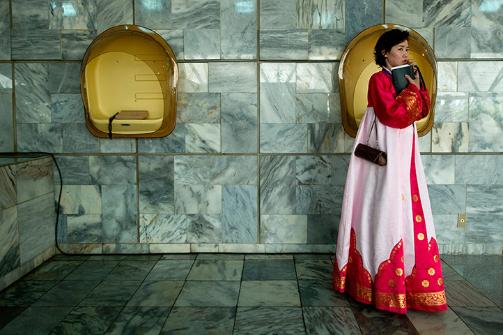 24 hours in pictures: A woman in traditional dress speaks on the telephone