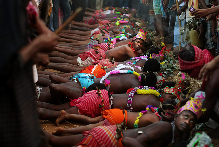 24 hours in pictures: Indian Hindu devotees lay on the ground during a brief ceremony