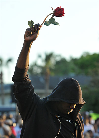 Trayvon Martin: Protestor wearing a hoodie and holding a rose