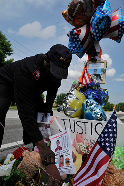Trayvon Martin: A man leaves a flyer at the memorial dedicated to Trayvon Martin