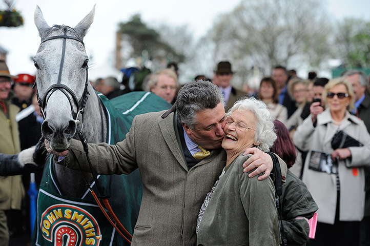 National: Paul Nicholls kisses his mother Margaret as he celebrates winning the race