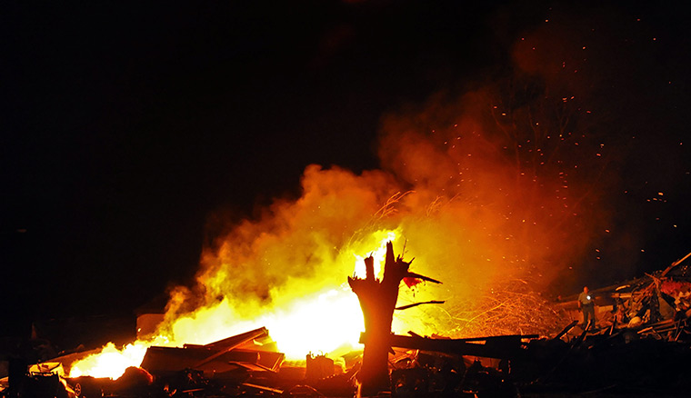 Tornados: A police officer, right, searches a trailer park in Wichita, Kansas
