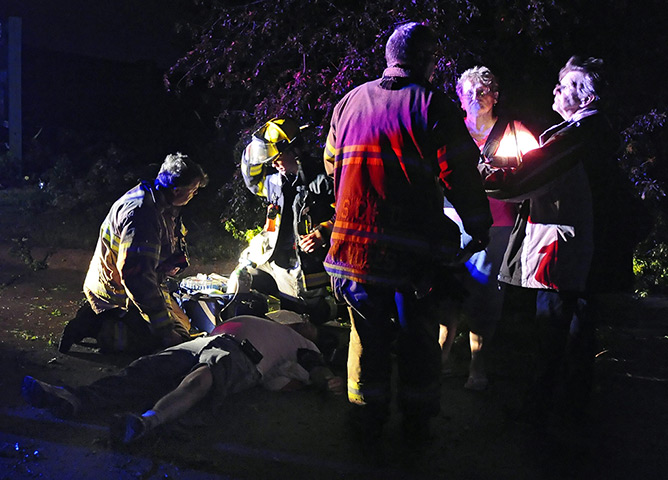 Tornados: A man is treated by paramedics in a trailer park in Wichita, Kansas