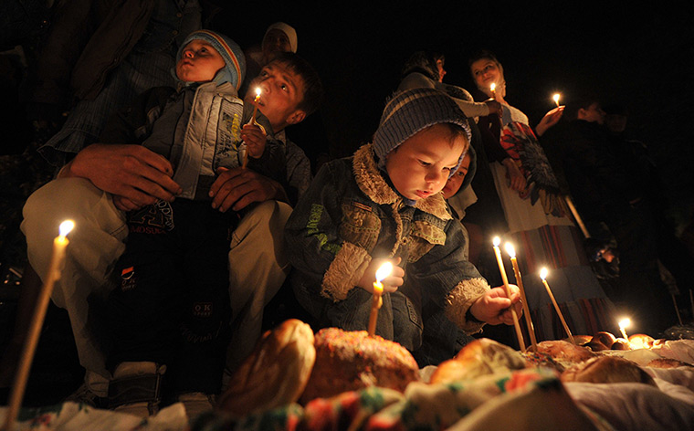 Orthodox Easter: Orthodox believers light candles during a mass in Bishkek, Kyrgyzstan 