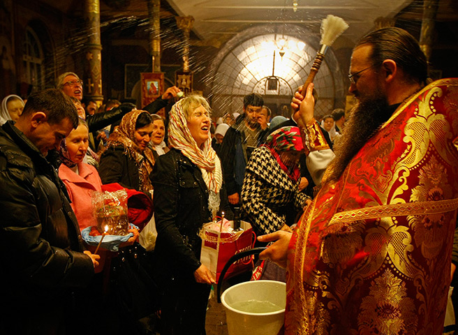 Orthodox Easter: A priest blesses worshipers at Kievo-Pecherskaya Lavra cathedral in Kiev
