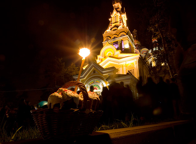 Orthodox Easter: A candle is placed on Kulich cakes at the Voznesenskiy cathedral in Almaty