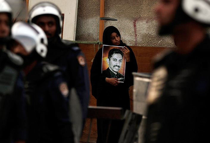 24 hours: Manama, Bahrain: An anti-government protester holds a picture of al-Khawaja