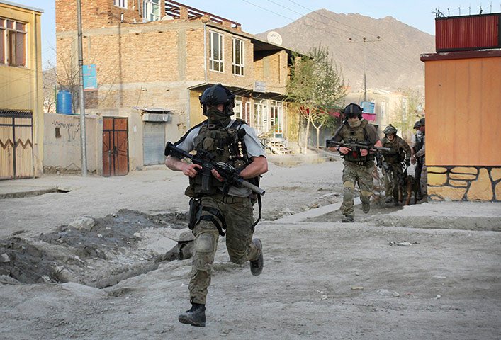Afghanistan attacks: NATO soldiers run during a gun battle in Kabul, Afghanistan