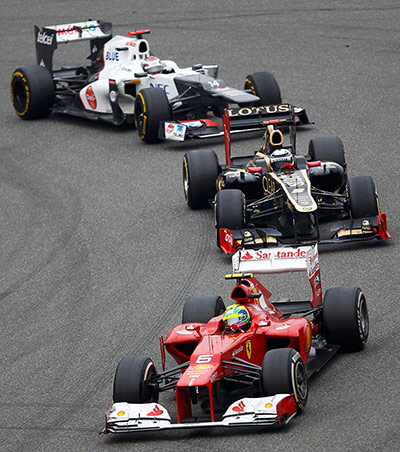 Chinese Grand Prix: Felipe Massa in the Ferrari leads the Lotus of Kimi Raikkonen 