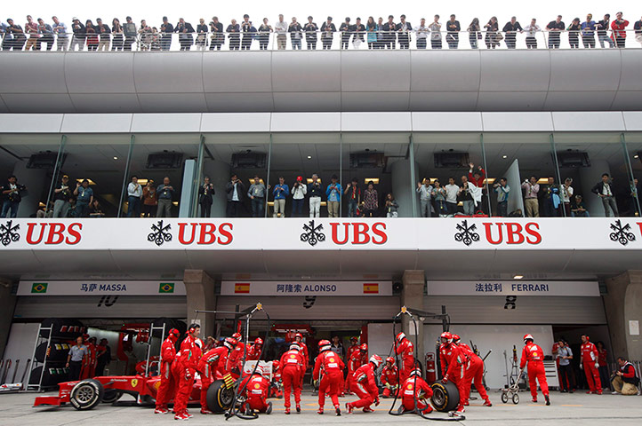 Chinese Grand Prix: A crowd watches as the Ferrari mechanics