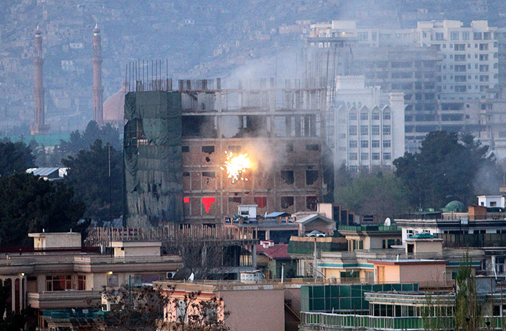 Afghanistan violence: Gunfire and smoke from a building occupied by militants during a battle