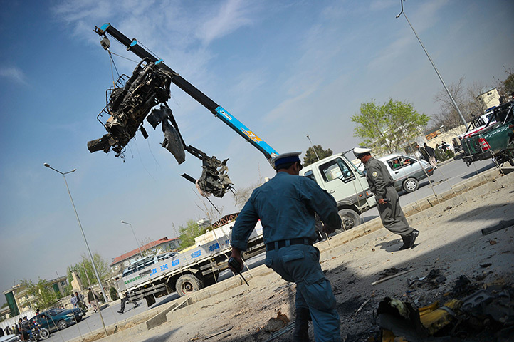 Afghanistan violence: Police remove the wreckage of a car in Kabul