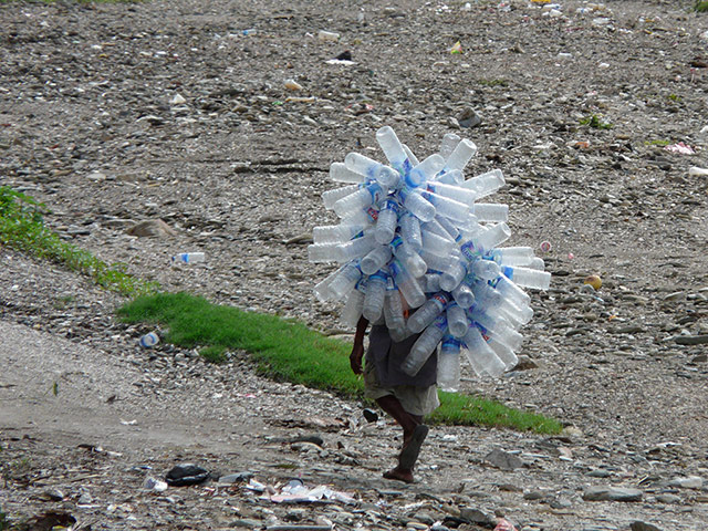 Your Pictures: Your Pictures: a man carrying empty water bottles on his back