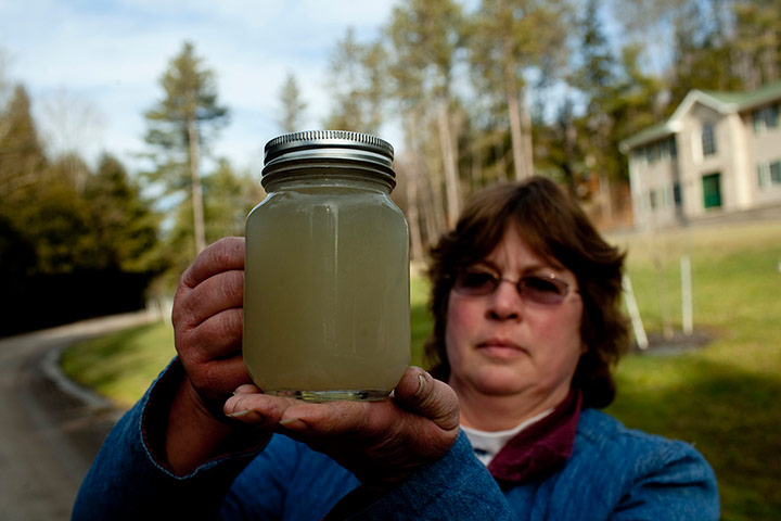 Fracking in Pennsylvania: Carol French holds a jar of cloudy water from her well  Pennsylvania