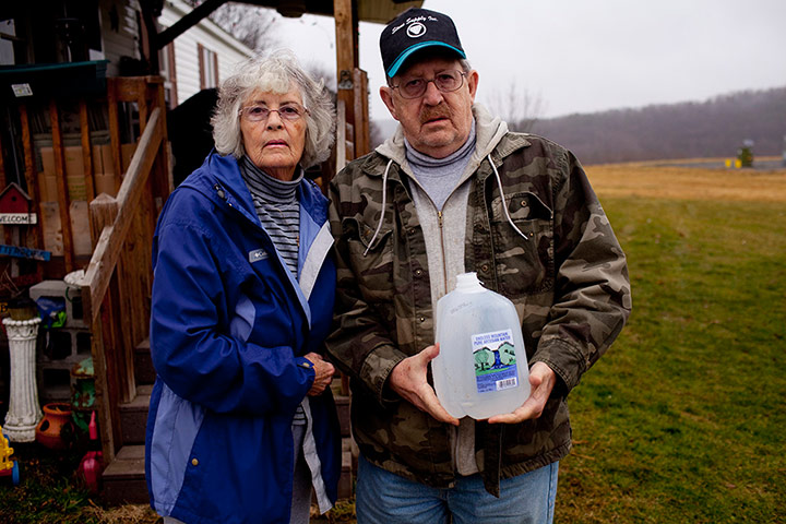 Fracking in Pennsylvania: Ron and Jean Carter hold a bottle of their well water Pennsylvania