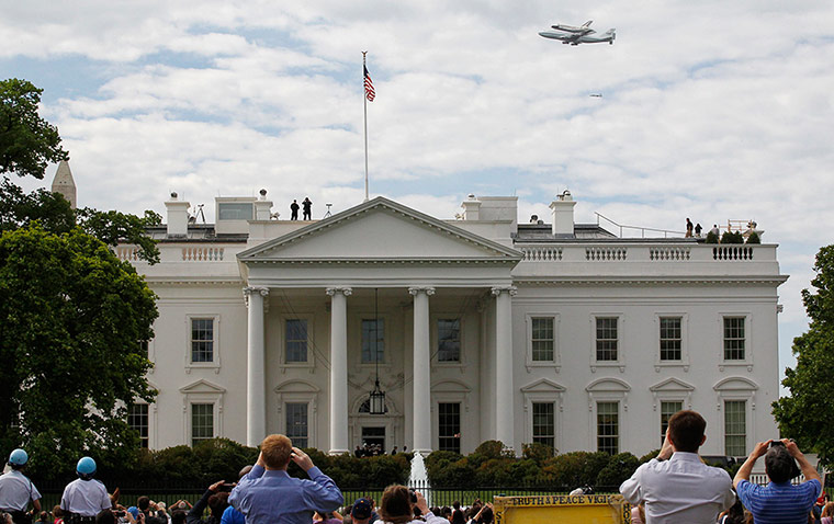 Space Shuttle: The space shuttle Discovery does a final fly-by over the White House