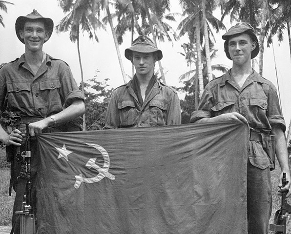 Colonial papers: Three British Soldiers Holding Communist Flag