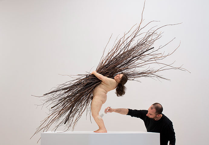 Ron Mueck exhibition: Finshing touches to 'Woman with sticks' 2008 (Mixed Media) by Ron Mueck