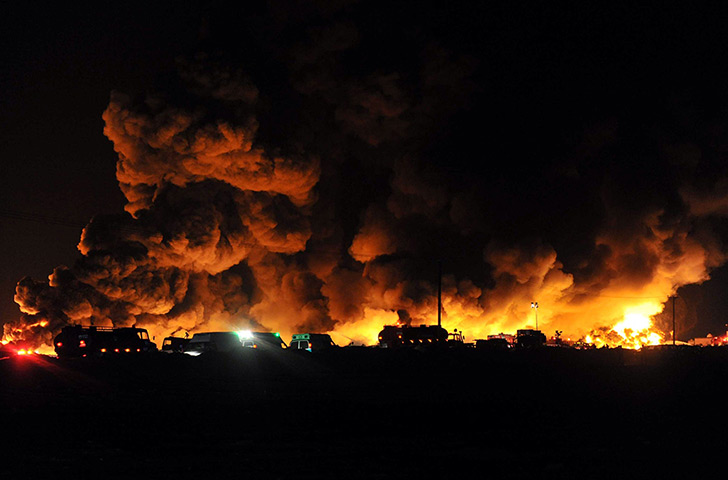 24 hours: Kuwait city, Kuwait: Firemen at a massive fire in a dump of used tyres