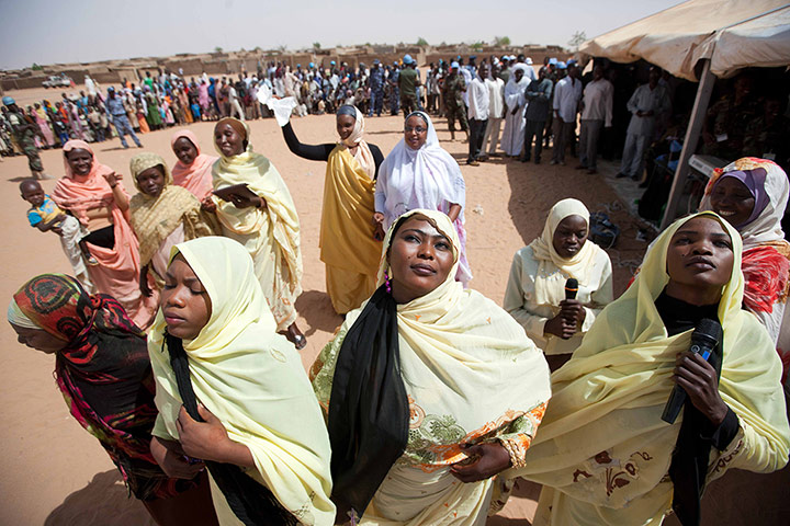 Picture Desk Live: Women celebrate the opening of classrooms in the IDP camp in north Darfur