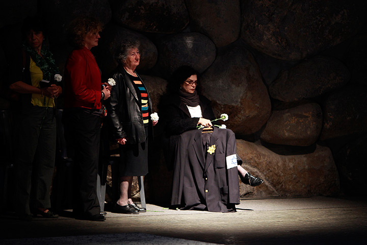 Holocaust memorial: Women hold flowers at Yad Vashem Holocaust Memorial in Jerusalem
