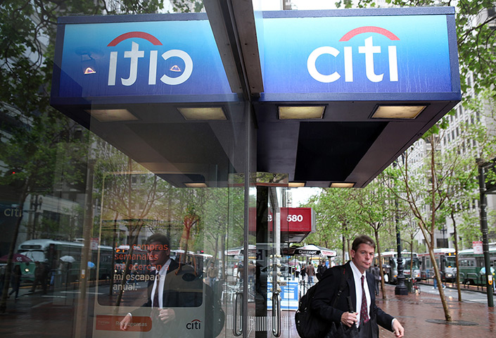 Week in Business: A customer leaves a CitiBank branch office in San Francisco