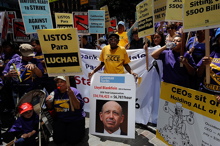 Week in Business: Demonstrator holds Goldman Sachs CEO sign in protest against US tax system