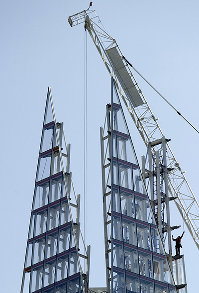 24 hours: London, England: A builder installs glass panels near the top of the Shard