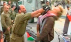 Israeli soldier Shalom Eisner strikes Danish protester Andreas Ias with his rifle