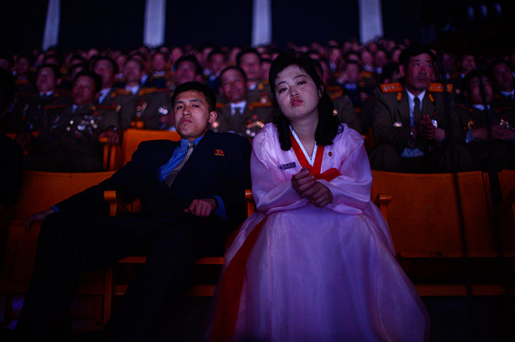Longer view: North Koreans watch a performance in a theatre